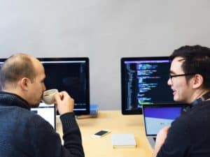 developers-discussing-javascript-code_925x